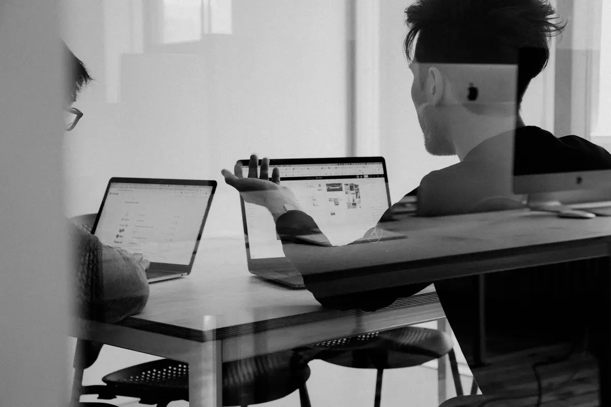Team reviewing software quality results on a laptop
