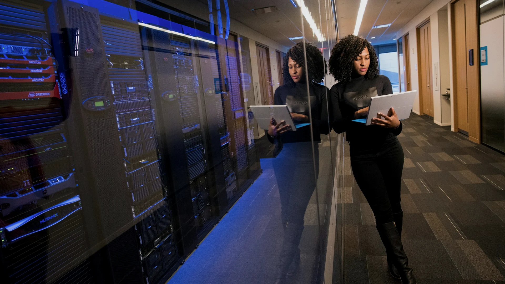 Cloud consultants walking a client data center aisle during workload discovery and assessment