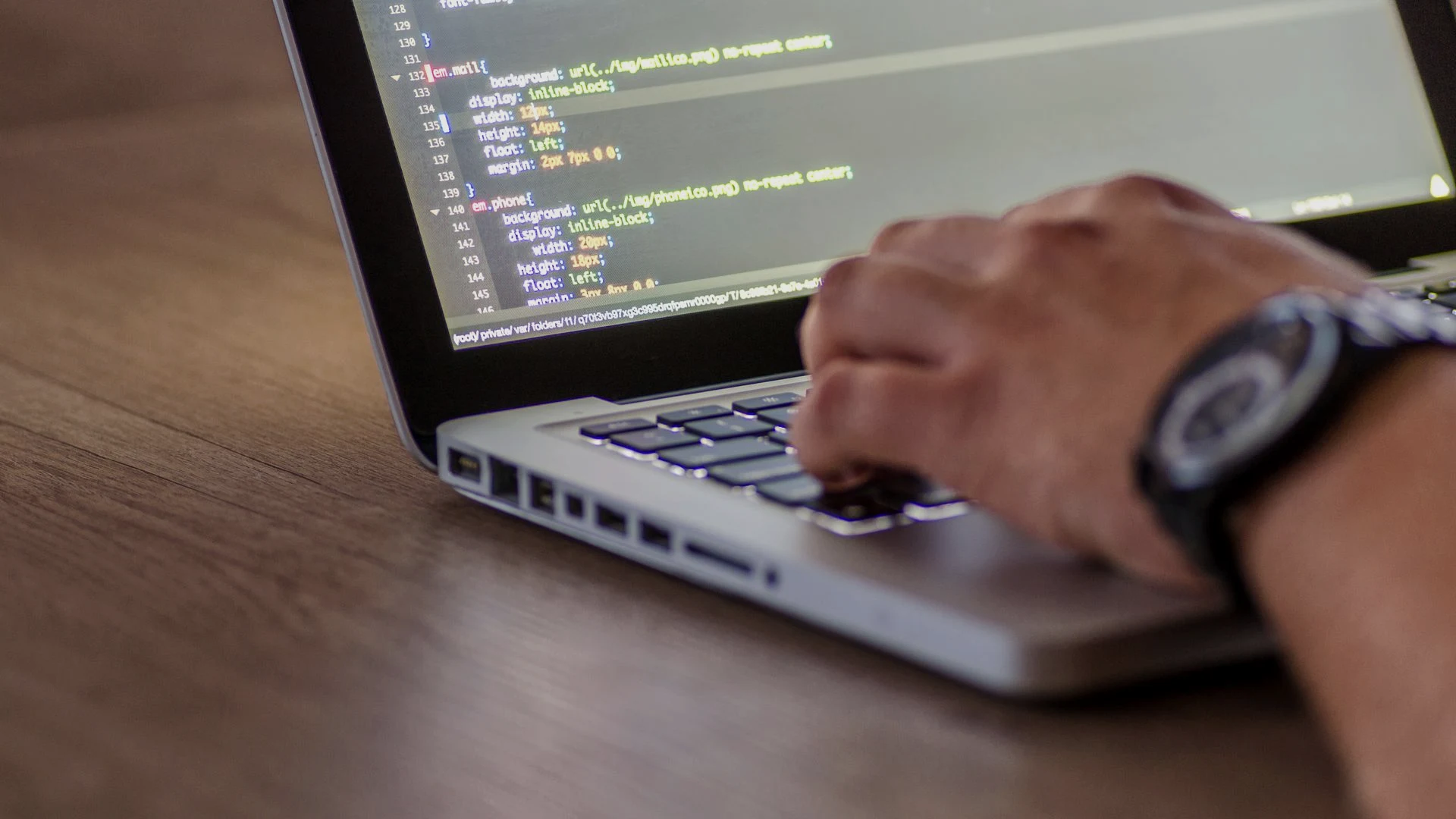 Developer typing application logic on a laptop during an agile sprint focused on iterative software delivery